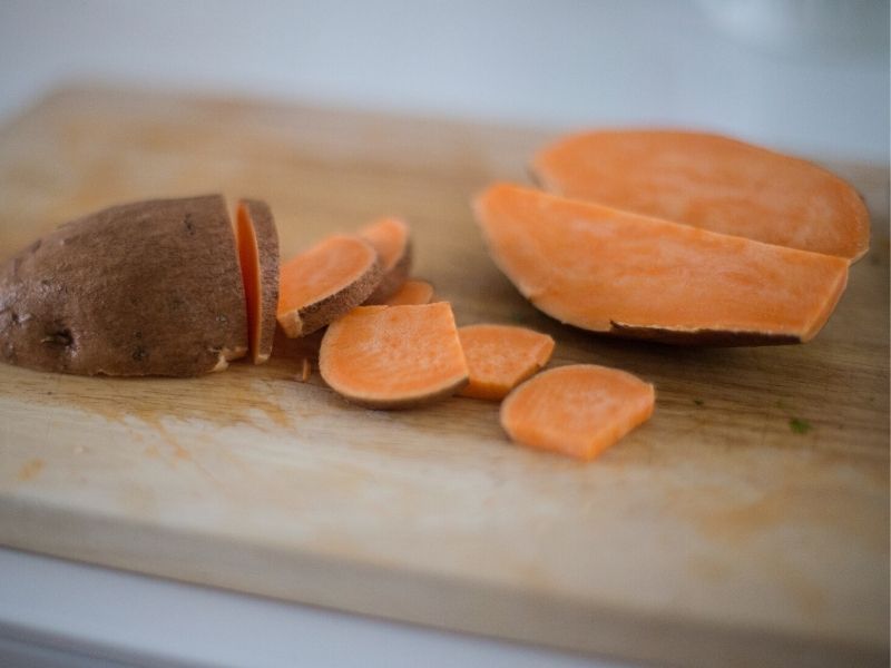 sweet potatoes on wooden cutting board, baby first solid food