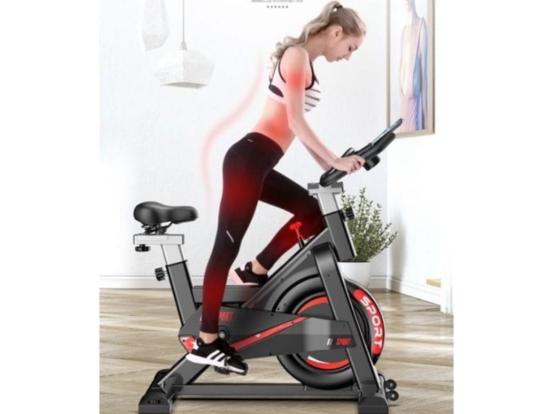 Girl working out on exercise bikes