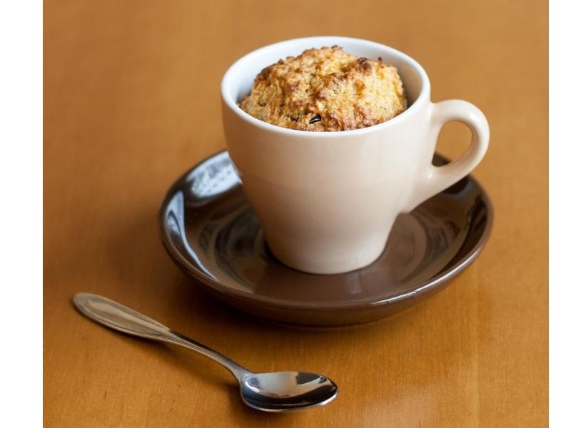 microwave mug cake with spoon beside it