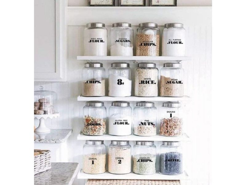 kitchen cabinet organization with clear jars and labels