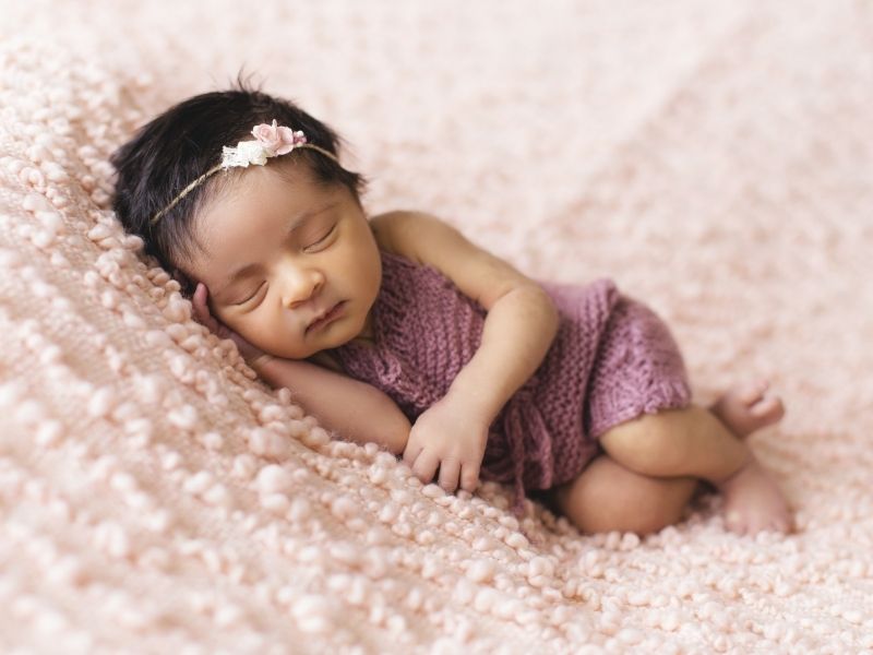 baby girl sleeping on blanket feature image