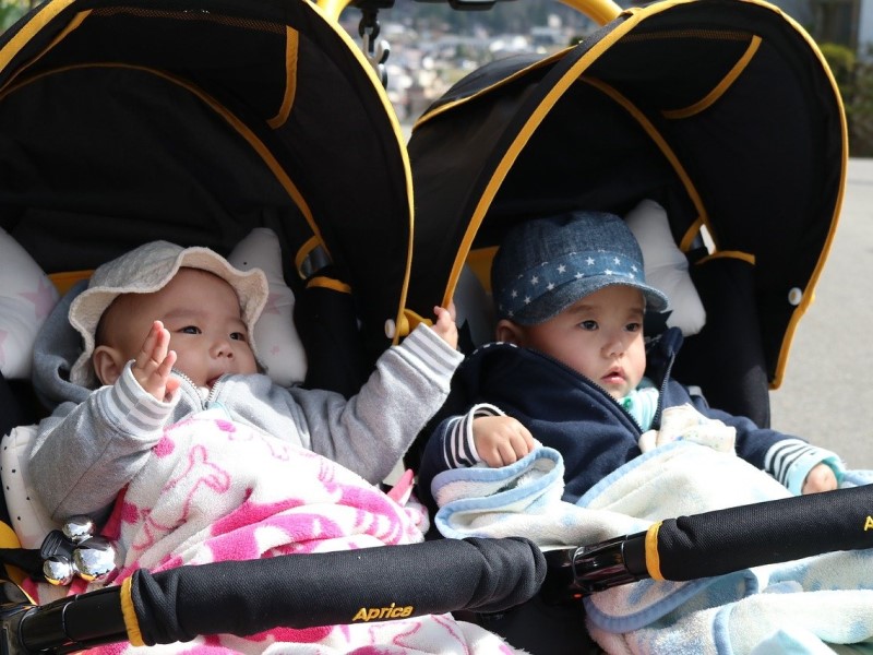 asian twins in double pram