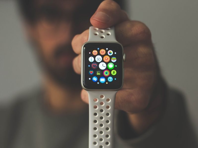 a man holding an apple watch