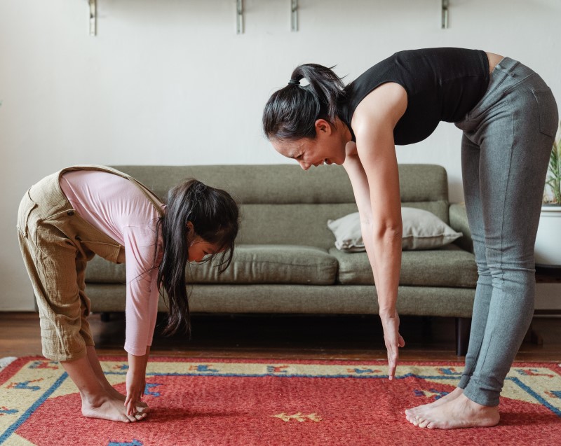 mother and daughter touching toes