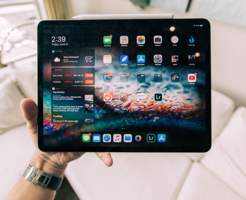 man holding ipad tablet 