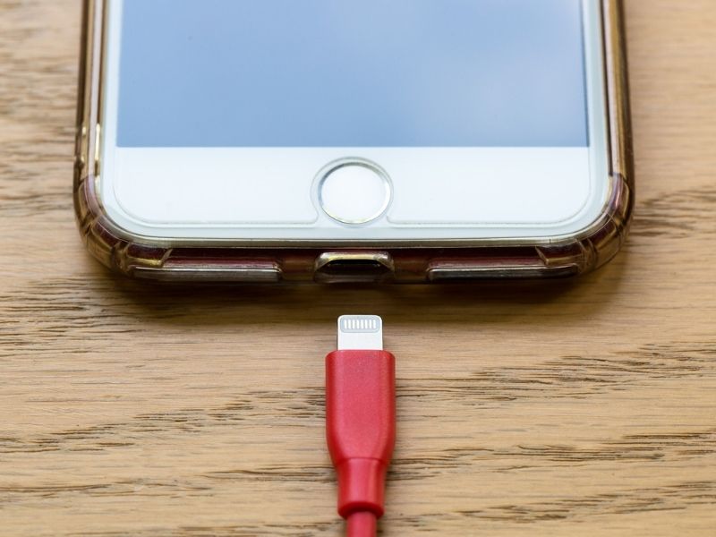 An iphone and a lightning cable