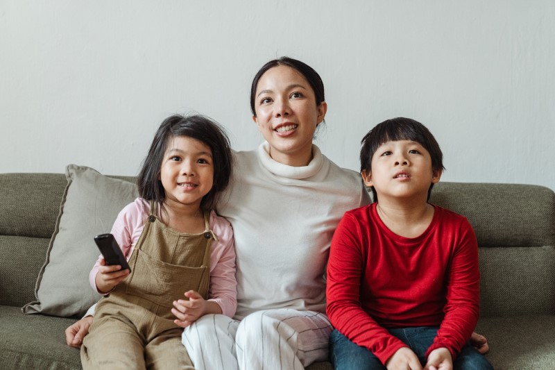 kids and mom watching tv together 