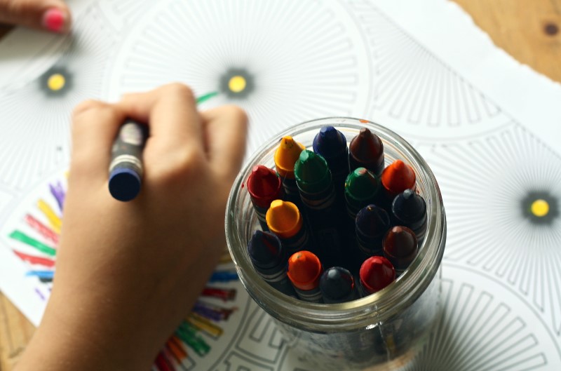 kid colouring with crayon