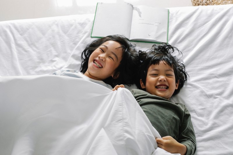 kids laughing in bed