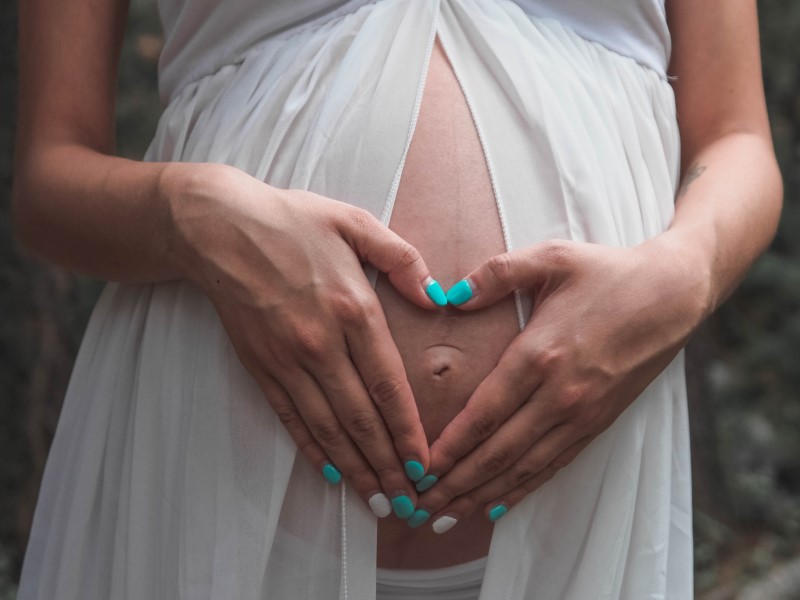 pregnant woman holding stomach 