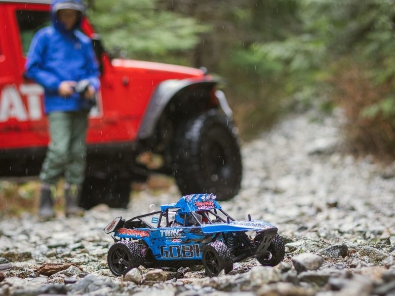 A person playing with a remote control car