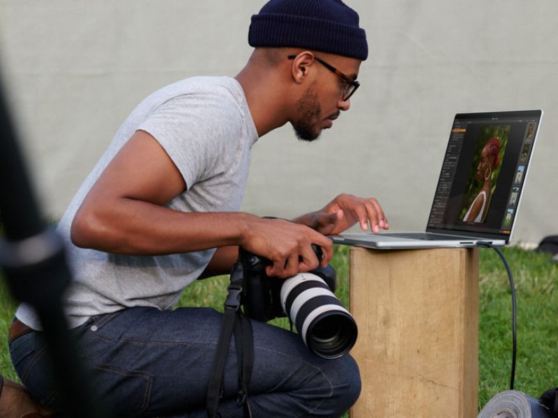 a photographer working on a MacBook Pro 16-inch