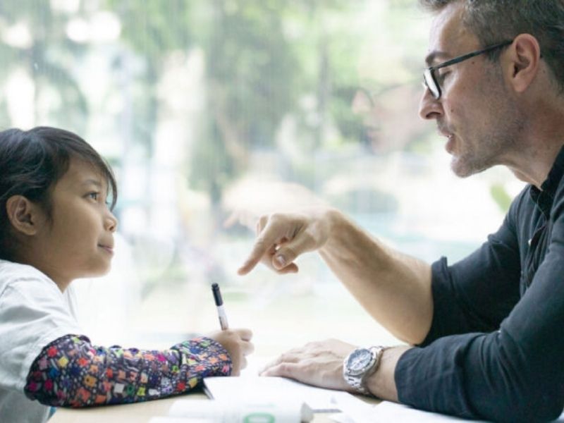 an adult tutoring a child