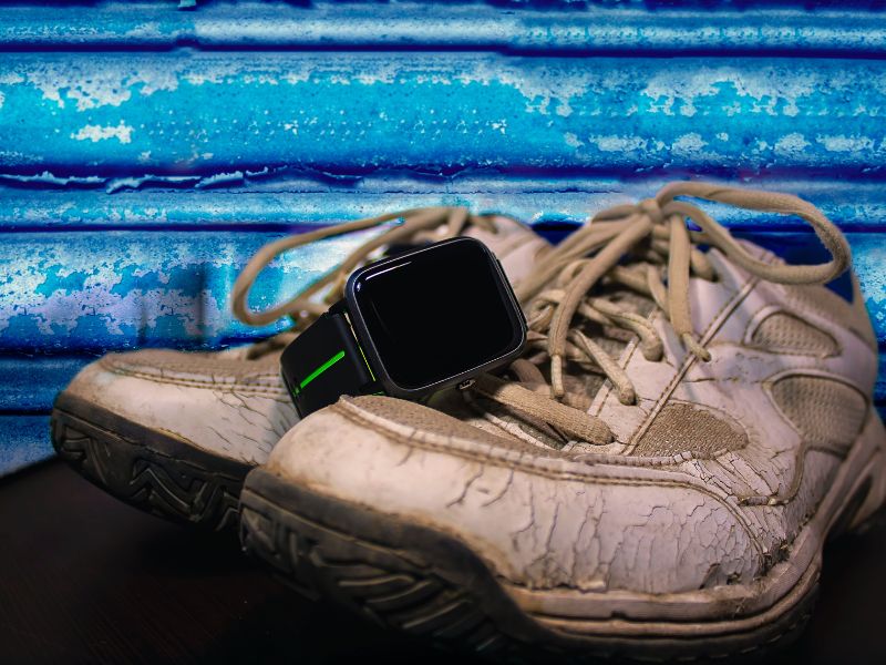a smartwatch on top of a pair of shoes