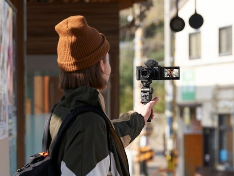 A lady vlogging with a camera