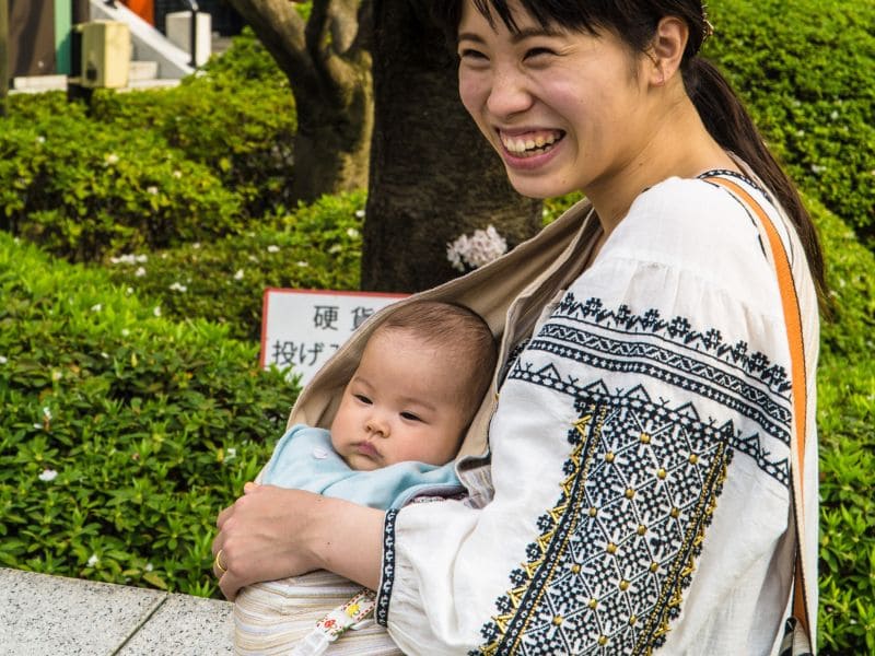 a woman carrying a baby
