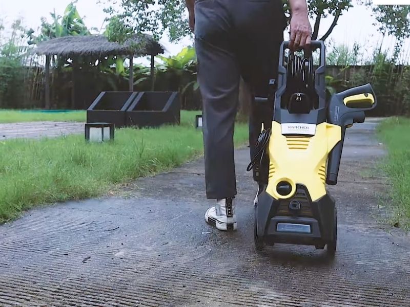 a man towing a pressure washer