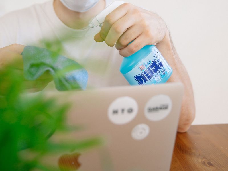 a man preparing to clean a laptop