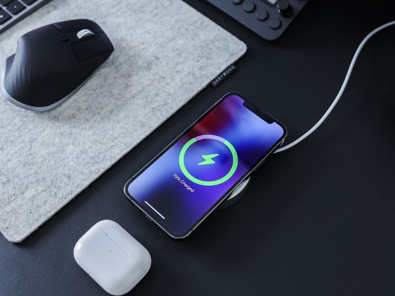 an iPhone charging on a wireless charger