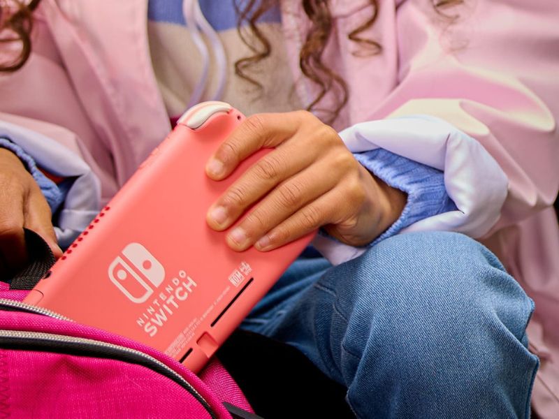 a person pulling out the Nintendo Switch from a bag