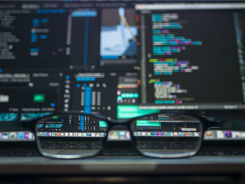 a pair of eyeglasses sitting on top of a laptop keyboard