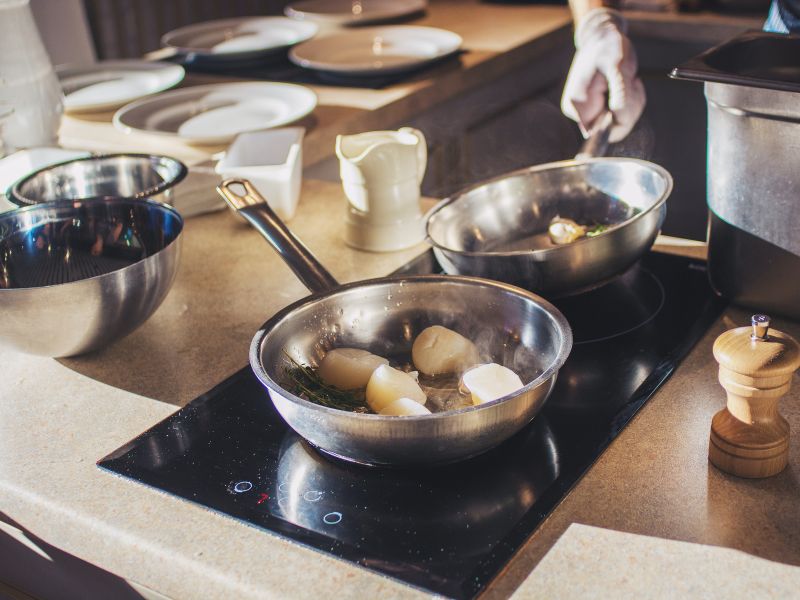 a person cooking with an induction cooker