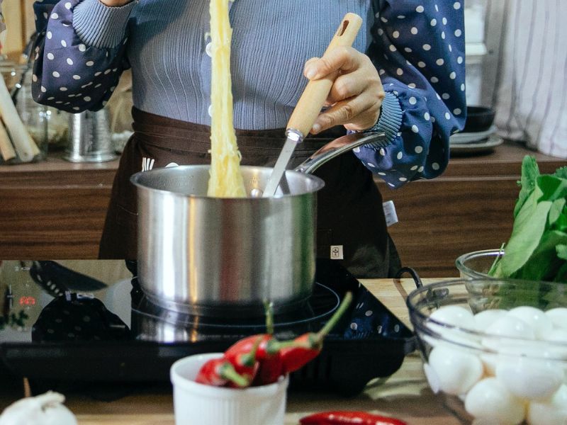 a lady cooking in a kitchen