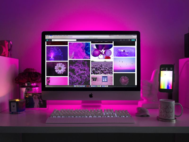 a desk setup bathed in pink glow bedroom gaming room