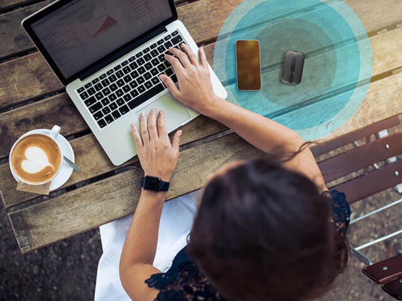 A woman using a laptop outdoors