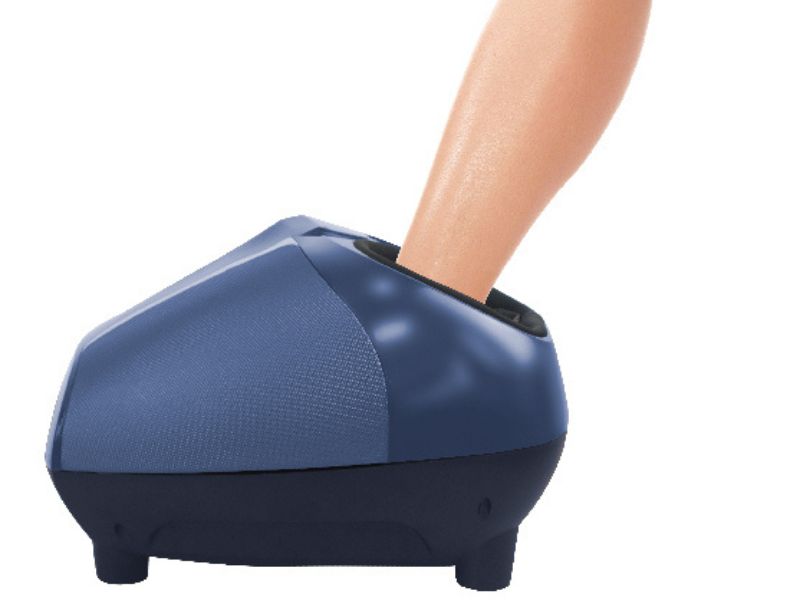 A foot inside a foot massage machine