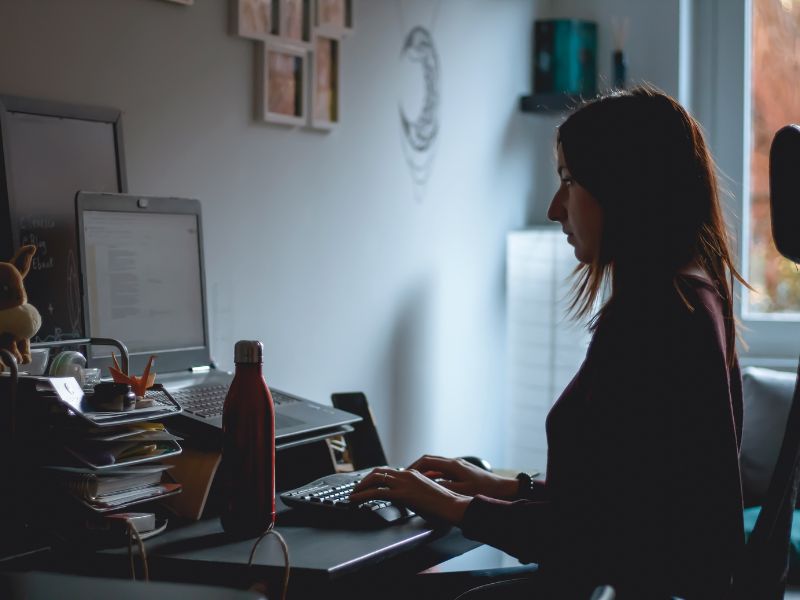 a woman typing on a keyboard