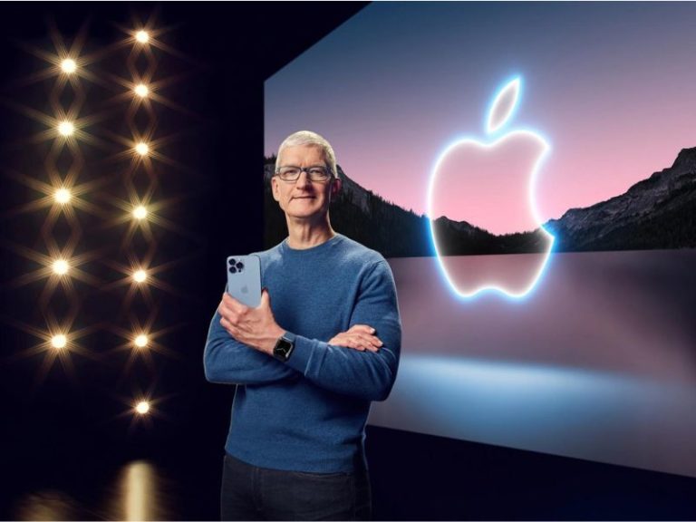 Tim Cook posing with Apple products