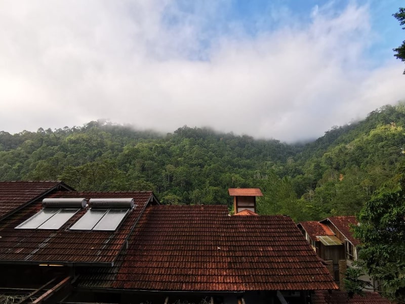 a view of a hill behind a rooftop