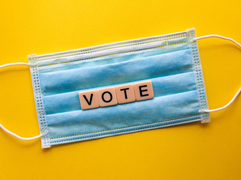 the word "vote" formed on top of a face mask