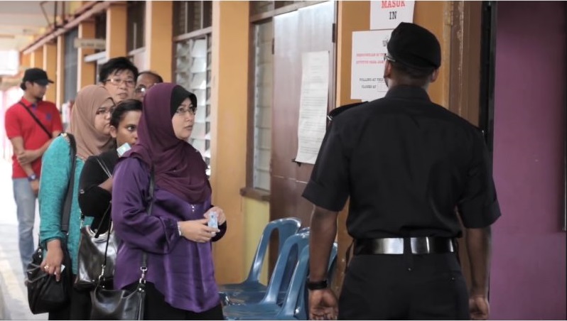 People lining up to enter a polling centre