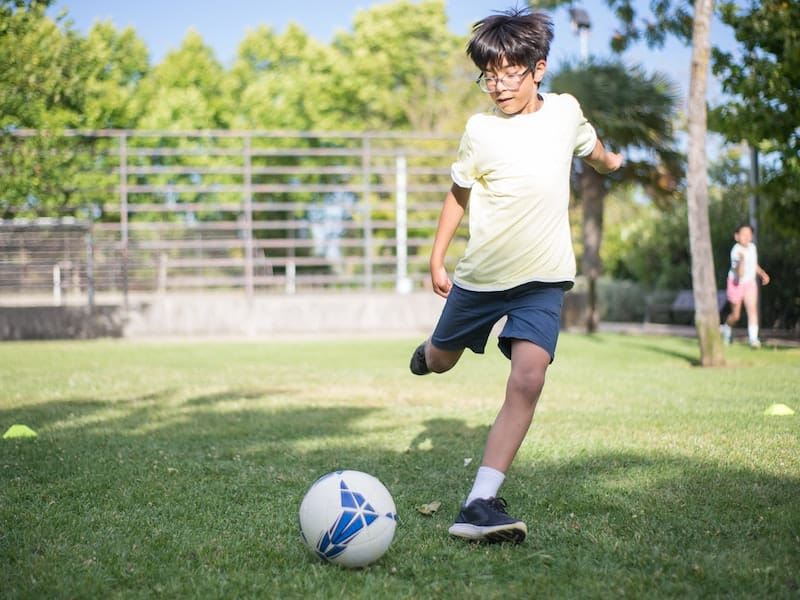 a boy about to kick a ball