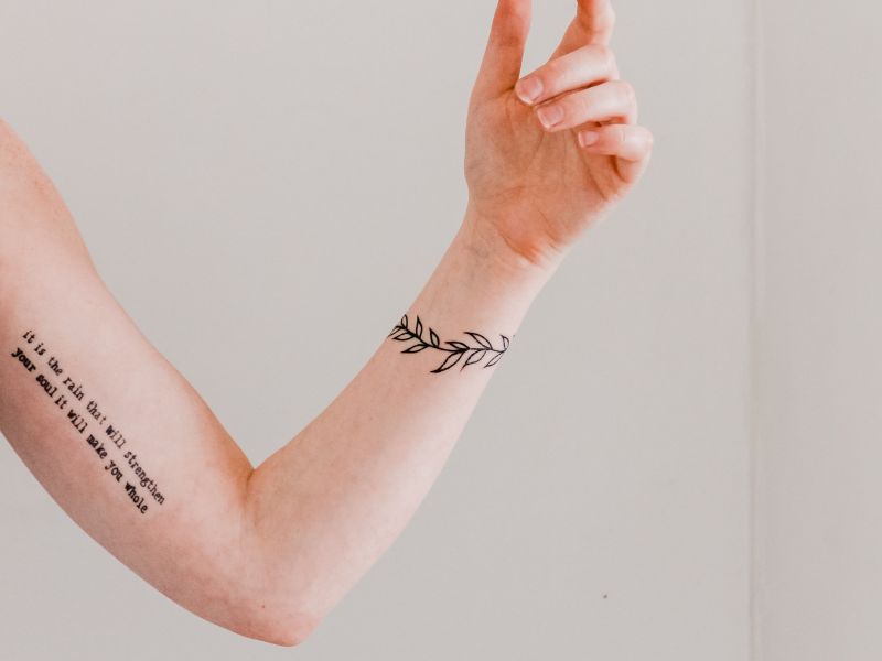 A hand and arm with tattoos