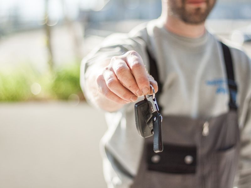 A man holding car keys