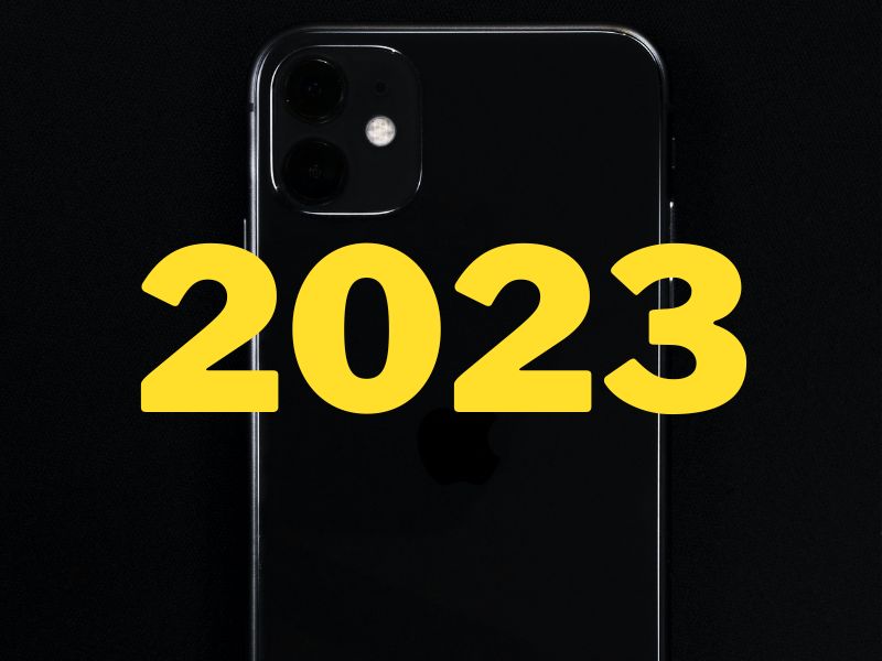 The word 2023 in front of a smartphone silhouette