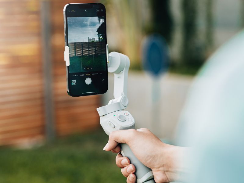 a person holding a gimbal for phone