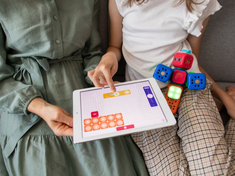 An adult and a child looking at a tablet tablets for kids