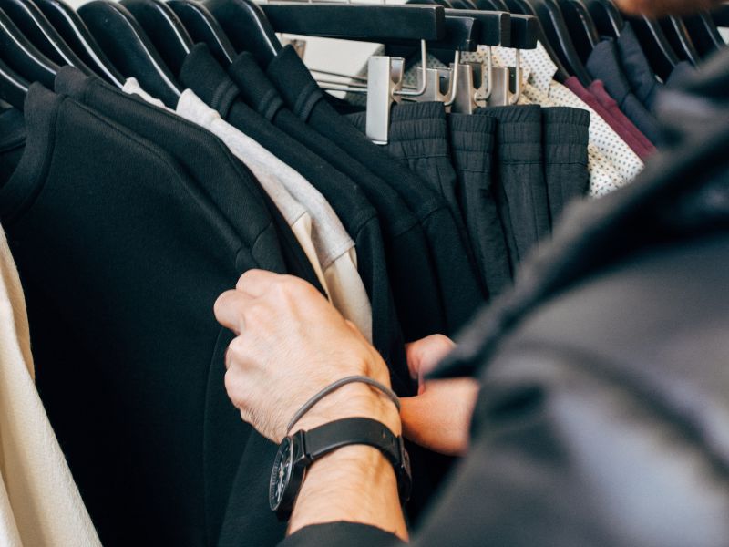 a person browsing clothes on a rack father’s day celebration ideas