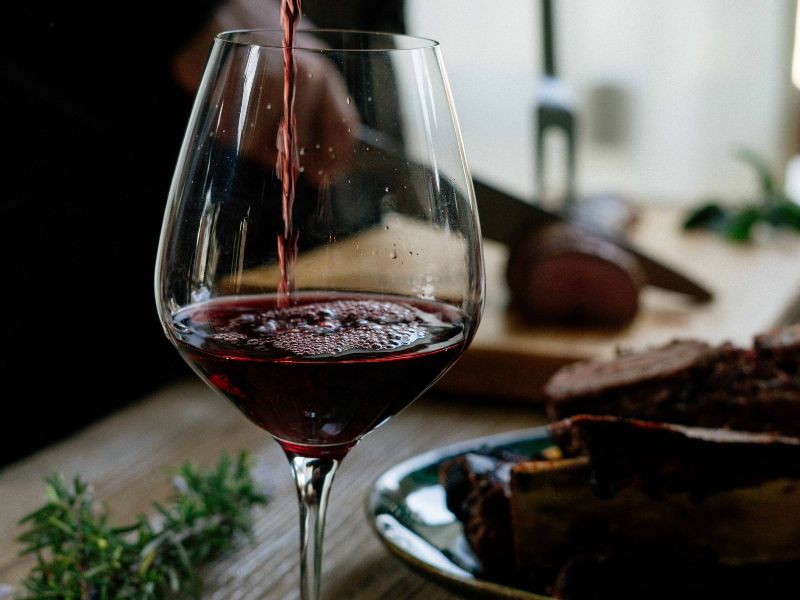 liquid being poured into a wine glass