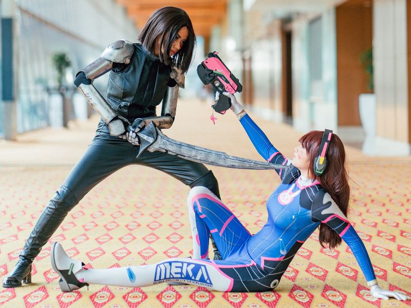 two cosplayers enacting a battle scene