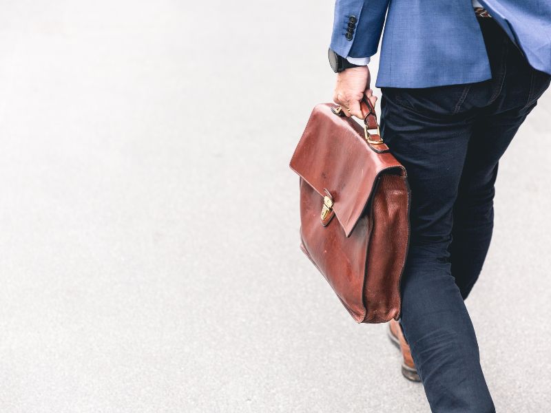 a man holding a briefcase online scams in malaysia