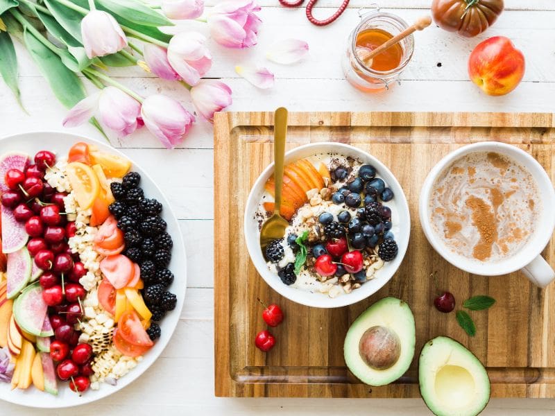 fruits on plate, bowls, and tray