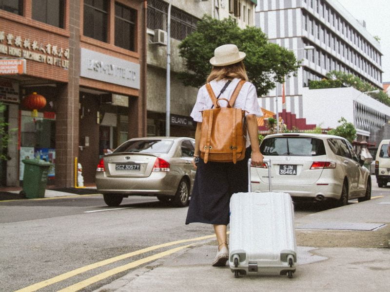 a lady pulling a luggage bag