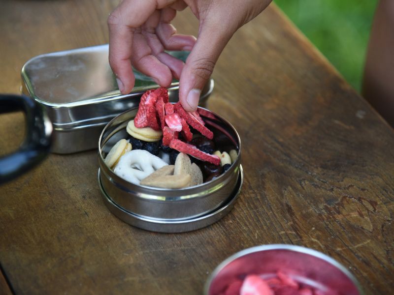 a person putting food into a container