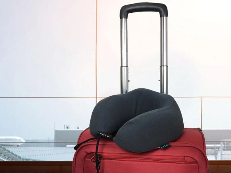 a travel pillow on a luggage bag