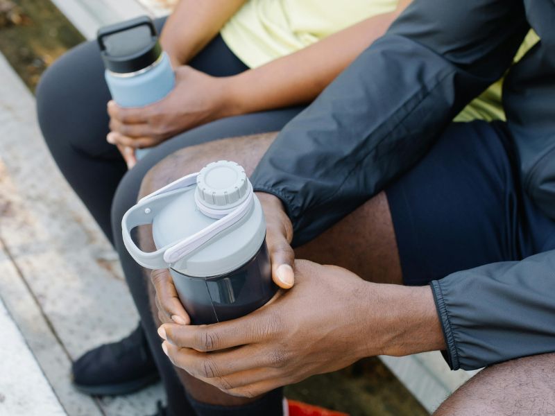 people holding tumblers